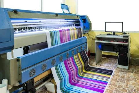 Large inkjet printer working multicolor cmyk on vinyl banner with computer co Stock Photos