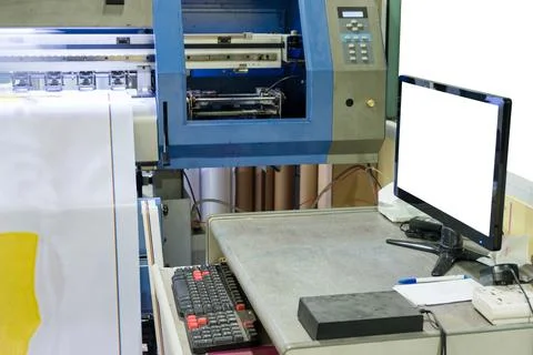 Large inkjet printer working on vinyl banner with computer screen Stock Photos