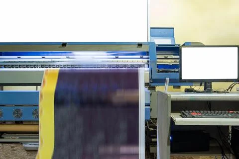Large inkjet printer working on vinyl banner with computer Stock Photos