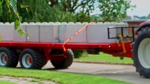 Large interlocking concrete security blocks barriers transport by rural tractor Vídeo Stock 315266429