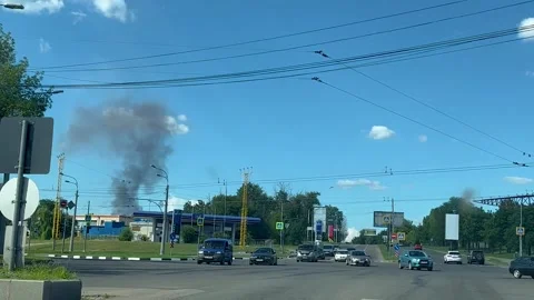 A large intersection in the city. A fire is visible from the side, a thick Stock Footage 279710434