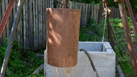 Large iron bucket on a chain Stock Footage 115106899