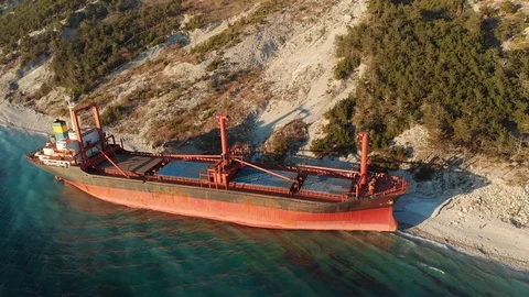 Large iron cargo ship run aground at sea bay. Industrial sea vessel shipwreck on Stock Footage 109135545