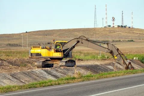 A large iron excavator at the construction site Stock Photos