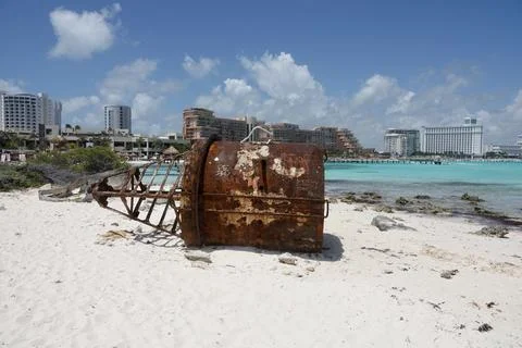A large iron rust buoy on a sandy beach by the sea in Cancun, Mexico. Nautical Stock Photos