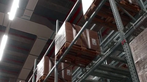 Large iron shelves with boxes in the warehouse. Stock-Footage 79192320