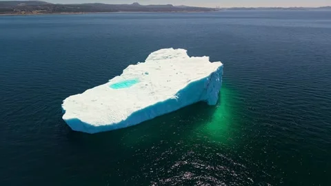Large Irregular Iceberg Cracked Face Turquoise Pool Aerial Newfoundland Video stock 334648976