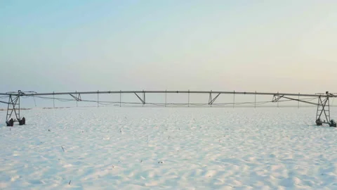 A large irrigation system on  a field covered with snow Stock Footage 168636942