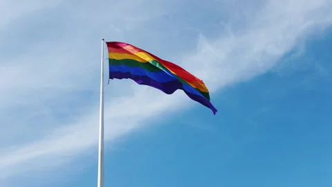 Large isolated rainbow flag on pole, which is an lgbtq pride symbol, 動画素材 131066425