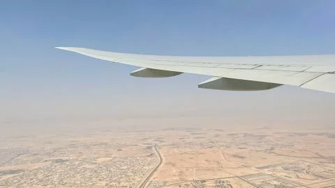 Large jetliner flying through a cloudy sky Stock Photos