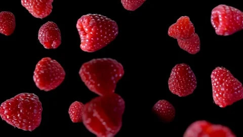 Large juicy appetizing raspberries bouncing on the black background Stock Footage 287087390