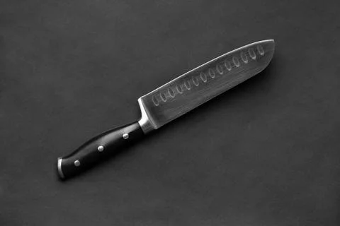 Large kitchen knife on a black background Stock Photos