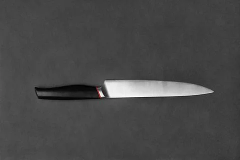 Large kitchen knife on a black background Stock Photos