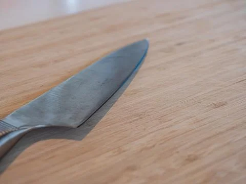 A large kitchen knife on a cutting board Stock Photos
