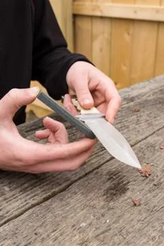 Large knife being sharpened Stock Photos