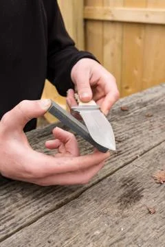 Large knife being sharpened Stock Photos