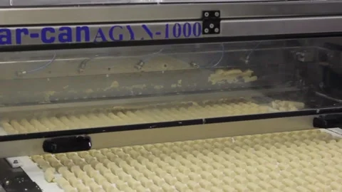 A large knife cuts blanks for making unglazed candy sweet bars Stock Footage 128643032