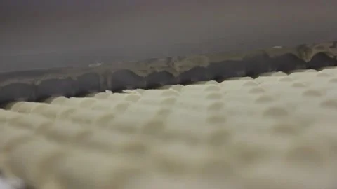 A large knife cuts blanks for making unglazed candy sweet bars Stock Footage 128643047