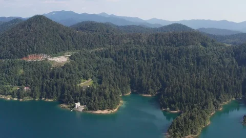 Large lake and a pine tree forest in the mountains Stock Footage 120691106