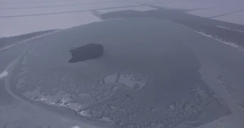 A large lake in the fog, a camera flies over a frozen lake Stock Footage 83558986