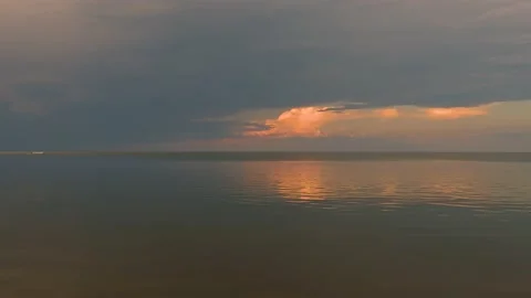 Large lake or ocean at sunset with small waves reflects clouds  Stock Footage 156978634