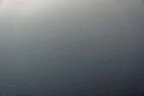 Large Lake with sun and cloud in reflection in disgusted sky Stock Photos