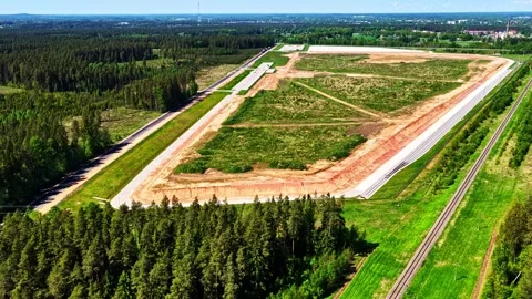 Large land development project near a forest and railway, industrial park plot Vídeos de archivo 337514956