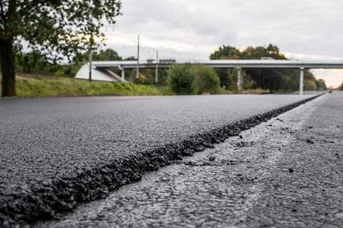 A large layer of fresh hot asphalt. Layer of asphalt raw material in a shallow Stock Photos