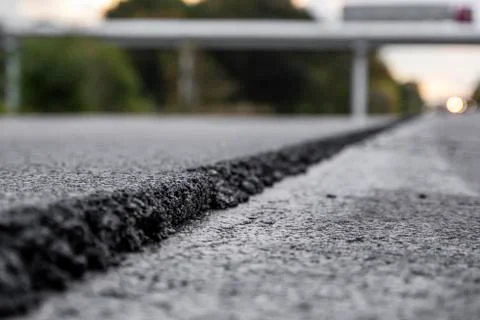 A large layer of fresh hot asphalt. Layer of asphalt raw material in a shallow Stock Photos
