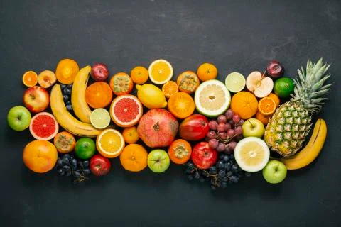 Large layout of a wide range of eco fruits on concrete. Fotos Stock