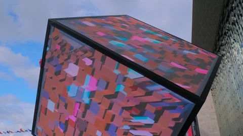Large LED cube with colorful visual show on screen walls: immersive art, day Stock Footage 344334635