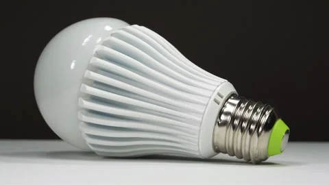 Large LED lamp with E27 base on black background Stock Footage 333574737