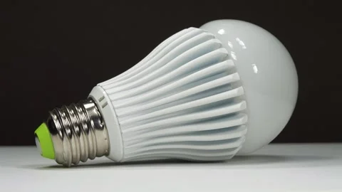 Large LED lamp with E27 base on black background Stock Footage 334002315