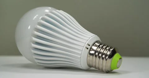 Large LED lamp with E27 base on grey backdrop Stock Footage 335108802
