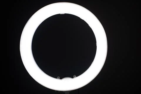 Large LED ring light in a studio room against empty walls front view and the  Stock Photos