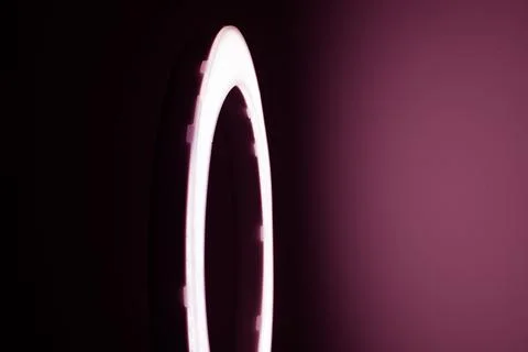 Large LED ring light in a studio room against empty walls side view, light bo Stock Photos