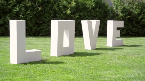 Large letters LOVE on the grass Stock Footage 42907047