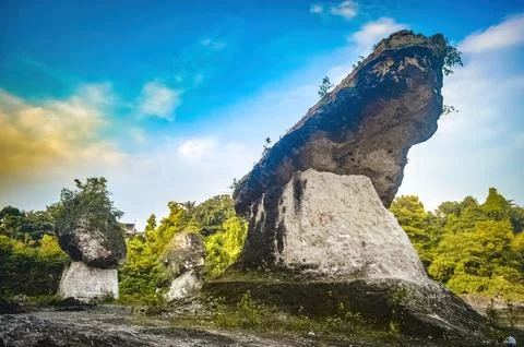 Large limestone rock eroded by mining activity in a limestone quarry Stock Photos