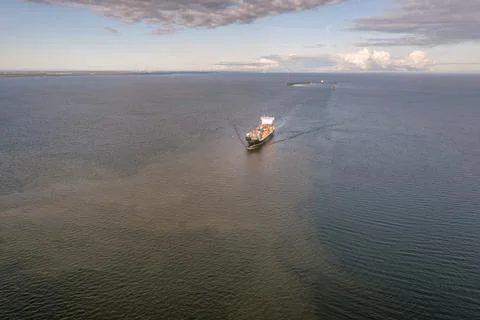 Large loaded container ship sailing high seas. Aerial high angle view Foto stock