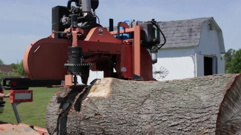 Large log being cut on portable sawmill Stock Footage 40472146