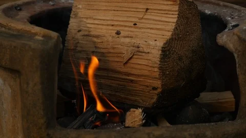 Large log is thrown onto a fire pit Stock Footage 115057412