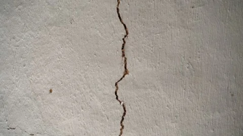 A large long crack in the ceiling of an old house. Camera movement parallel to Stock Footage 210498595