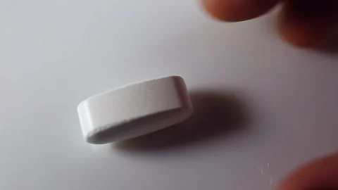 Large long oval tablets, put in the frame, and then remove them. On a white back Stock Footage 144643571