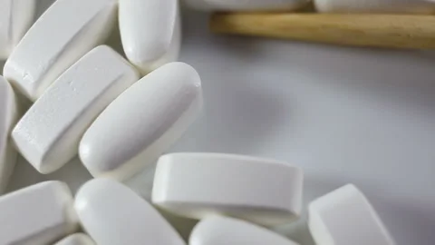 Large long shiny tablets in the shell are removed from the frame. On a white bac Stock Footage 144643470
