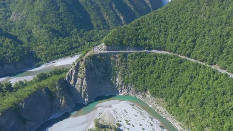 A large long train on a track with a mountain in the background 스톡 동영상 156849733