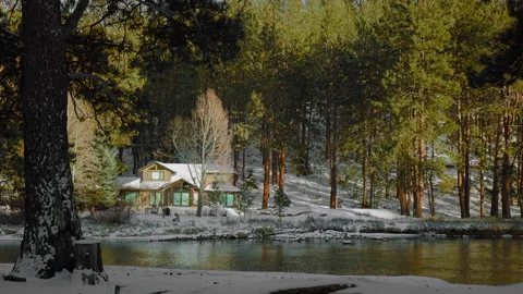 Large luxury home on on rippling river bank in winter Stock Footage 171106807