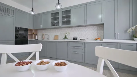 Large luxury moden classic gray kitchen with white dining table Stock Footage 158165715