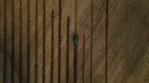 Large machine expertly lays pipes in a sprawling field. Stock-Footage 259326175
