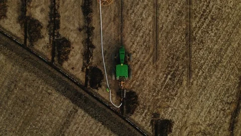 Large machine expertly lays pipes in a sprawling field. Stock-Footage 259326501