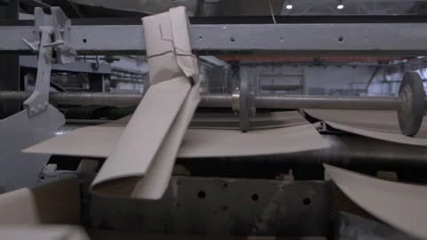 Large machine levels finished cardboard products in shop Видео 295152305